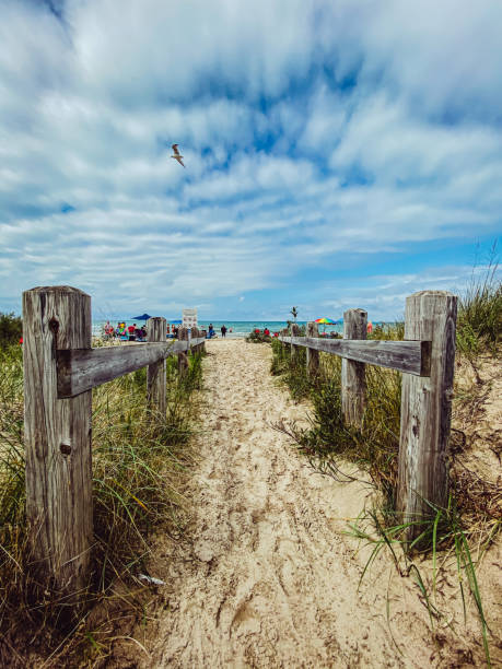 Sandy boardwalk path through wooden posts leading to Sauble Beach and Lake Huron